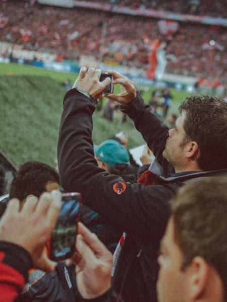 Spectator photographing the match on a phone
