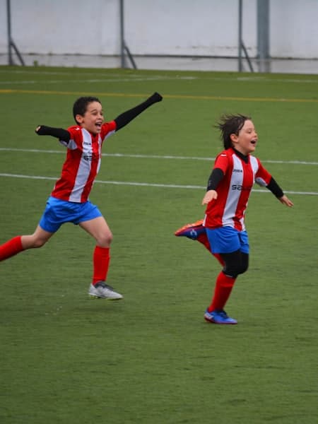 Two girls chasing the ball during a match