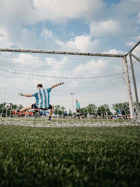 Player celebrating in front of the goal net