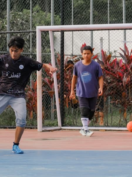 Two friends playing on an outdoor concrete court