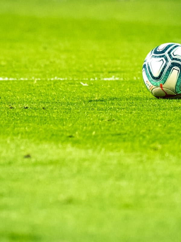 Match ball resting on the pitch line