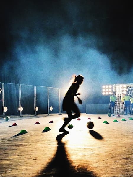 Player training alone under floodlights